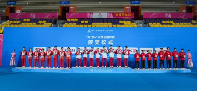 (251110) -- GUANGZHOU, Nov. 10, 2025 (Xinhua) -- Gold medalists team Shandong, silver medalists team Jilin and bronze medalists team Shaanxi are seen during the awarding ceremony for Wushu Taolu team event at China's 15th National Games in Guangzhou, south China's Guangdong Province, Nov. 10, 2025. (Xinhua/Jigme Dorji)
