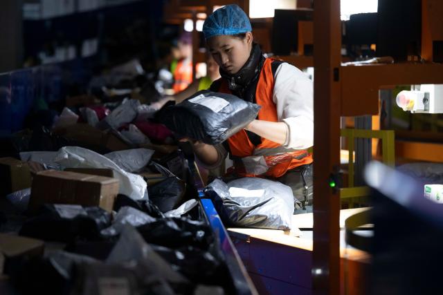 (251110) -- HARBIN, Nov. 10, 2025 (Xinhua) -- A staff member sorts parcels at a branch of China Post in Harbin, northeast China's Heilongjiang Province, Nov. 10, 2025. With the "Double Eleven" online shopping festival approaching, a branch of China Post in Harbin has taken measures to ensure package delivery. (Xinhua/Zhang Tao)