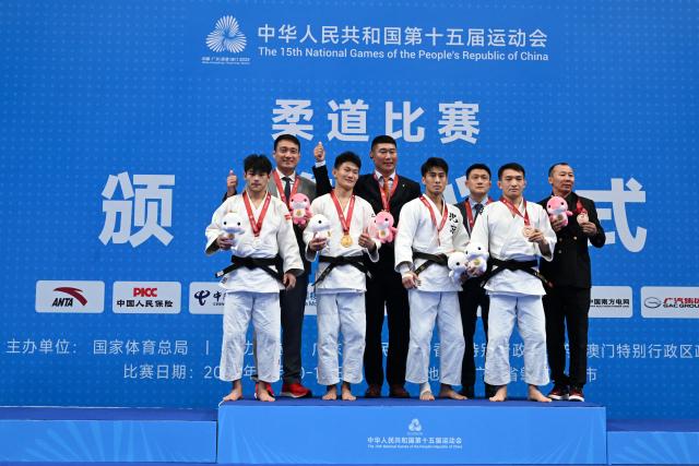 (251110) -- ZHAOQING, Nov. 10, 2025 (Xinhua) -- Gold medalist Ma Yulin of Shandong, silver medalist Wang Yuantao of Jiangsu, bronze medalist Hu Hao of Beijing and bronze medalist Wurinile of Inner Mongolia pose for photos with their coaches during the awarding ceremony of the men's Judo -60kg at China's 15th National Games in Zhaoqing, south China's Guangdong Province, Nov. 10, 2025. (Xinhua/Zhu Xiang)