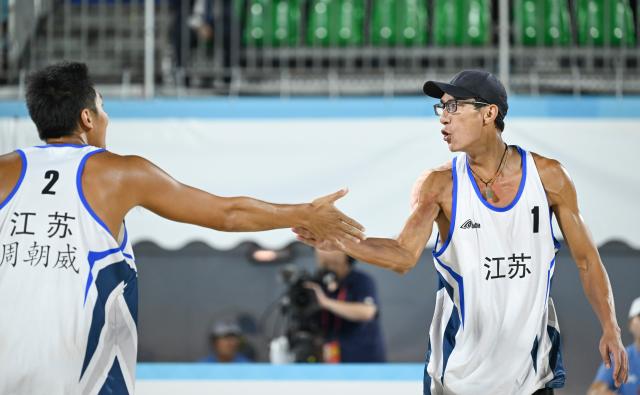 (251110) -- HONG KONG, Nov. 10, 2025 (Xinhua) -- Wu Jiaxin (R) of Jiangsu celebrates with his teammate Zhou Chaowei during the beach volleyball men's final between Wu Jiaxin/Zhou Chaowei of Jiangsu and Li Zhuoxin/Xue Tao of Liaoning at China's 15th National Games in Hong Kong, south China, Nov. 10, 2025. (Xinhua/Hu Huhu)