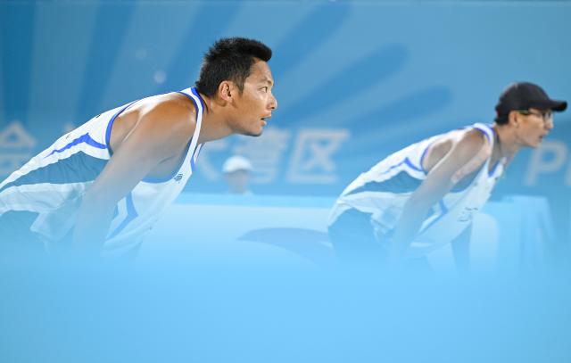 (251110) -- HONG KONG, Nov. 10, 2025 (Xinhua) -- Wu Jiaxin/Zhou Chaowei (L) of Jiangsu are seen during the beach volleyball men's final between Wu Jiaxin/Zhou Chaowei of Jiangsu and Li Zhuoxin/Xue Tao of Liaoning at China's 15th National Games in Hong Kong, south China, Nov. 10, 2025. (Xinhua/Hu Huhu)
