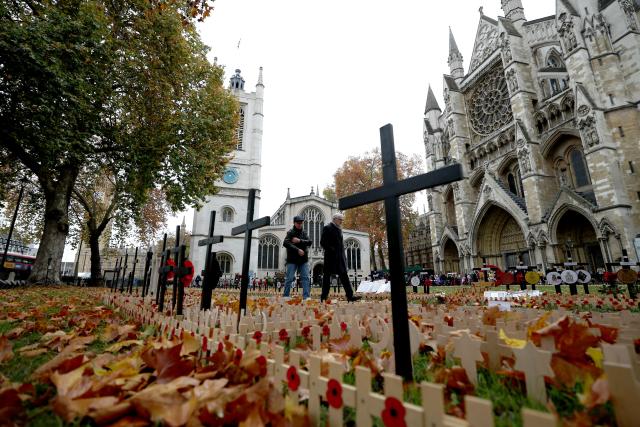 (251110) -- LONDON, Nov. 10, 2025 (Xinhua) -- People walk past poppy petals and crosses at the Field of Remembrance on the occasion of Remembrance Day at Westminster Abbey in London, Britain, Nov. 10, 2025. Remembrance Day is observed to remember the sacrifices made by soldiers during the WWI, which ended on Nov. 11, 1918. (Xinhua/Li Ying)