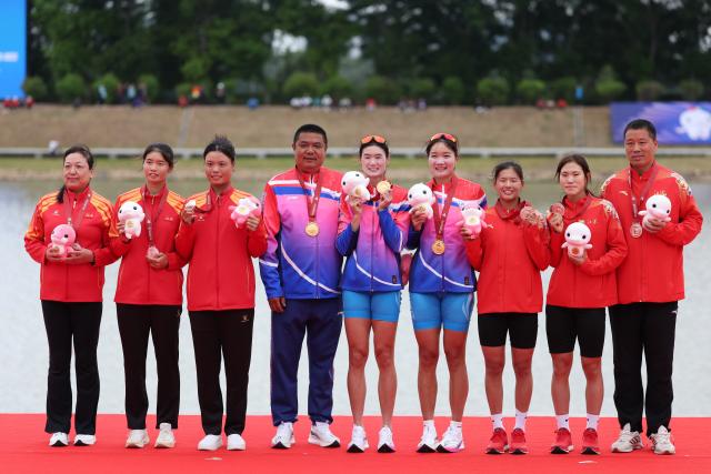 (251111) -- GUANGZHOU, Nov. 11, 2025 (Xinhua) -- Gold medalists Chen Yunxia/Zhang Ling of Shanghai (C), silver medalists Xie Lingli/Zhang Xinyu of Jiangxi (L) and bronze medalists Wang Yuxin/Liu Yuanyuan of Jiangsu pose with their coaches during the awarding ceremony after the women's double sculls final of rowing at China's 15th National Games in Guangzhou, south China's Guangdong Province, Nov. 11, 2025. (Xinhua/Pan Yulong)