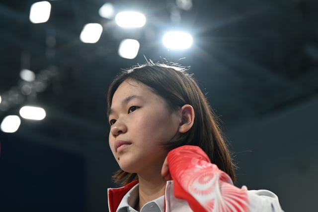 (251111) -- GUANGZHOU, Nov. 11, 2025 (Xinhua) -- Quan Hongchan reacts after the women's 3m springboard final of diving at China's 15th National Games in Guangzhou, south China's Guangdong Province, Nov. 11, 2025. (Xinhua/Xiao Yijiu)