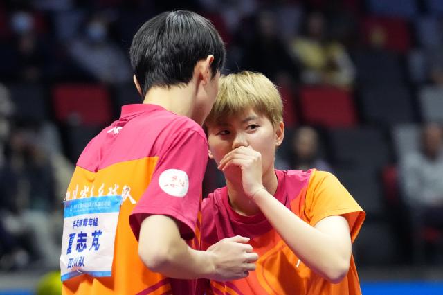 (251111) -- MACAO, Nov. 11, 2025 (Xinhua) -- Gao Yuxin (R)/Xia Zhipeng talk to each other during the table tennis U18 mixed doubles final match between Gao Yuxin/Xia Zhipeng of Sichuan and Luo Jiecheng/Yao Zixuan of Fujian at China's 15th National Games in Macao, south China, Nov. 11, 2025. (Xinhua/Lai Xiangdong)
