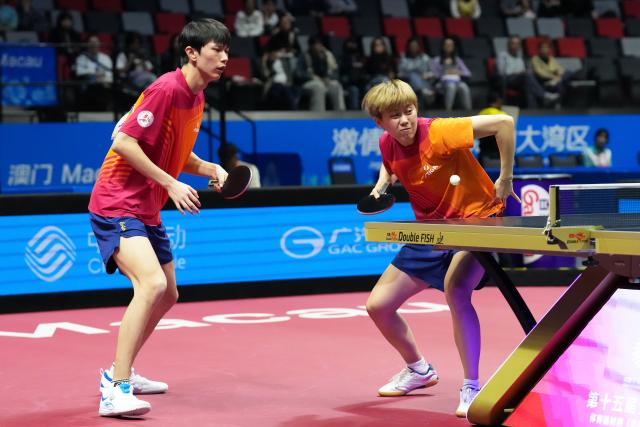 (251111) -- MACAO, Nov. 11, 2025 (Xinhua) -- Gao Yuxin (R)/Xia Zhipeng compete during the table tennis U18 mixed doubles final match between Gao Yuxin/Xia Zhipeng of Sichuan and Luo Jiecheng/Yao Zixuan of Fujian at China's 15th National Games in Macao, south China, Nov. 11, 2025. (Xinhua/Lai Xiangdong)