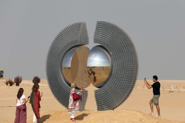 (251111) -- CAIRO, Nov. 11, 2025 (Xinhua) -- Visitors view an artwork exhibited during the "Forever Is Now" international art exhibition at Giza Pyramids scenic spot in Giza, Egypt, Nov. 11, 2025. The fifth edition of "Forever Is Now" international art exhibition on Tuesday kicked off in the area of Egypt's Giza Pyramids scenic spot, showcasing 10 artworks of artists from different countries. The exhibition runs from Nov. 11 to Dec. 6. (Xinhua/Ahmed Gomaa)