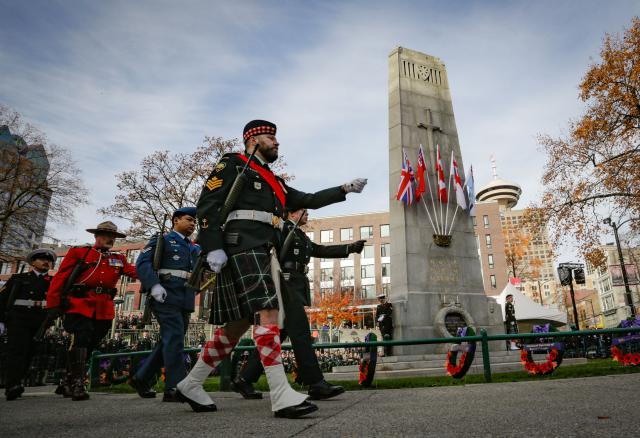 (251111) -- VANCOUVER, Nov. 11, 2025 (Xinhua) -- Vigil guards march in front of the Victory Square Cenotaph during a Remembrance Day ceremony in Vancouver, British Columbia, Canada, Nov. 11, 2025. (Photo by Liang Sen/ Xinhua)