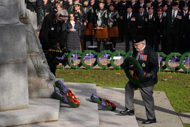 (251111) -- VANCOUVER, Nov. 11, 2025 (Xinhua) -- A World War II veteran places a wreath at the Victory Square Cenotaph during a Remembrance Day ceremony in Vancouver, British Columbia, Canada, Nov. 11, 2025. (Photo by Liang Sen/ Xinhua)