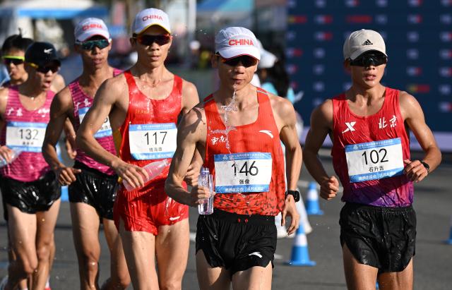 (251112) -- ZHUHAI, Nov. 12, 2025 (Xinhua) -- Zhang Jun (2nd R) of Yunnan, Shi Shengji (1st R) of Beijing and Qian Haifeng (3rd R) of Heilongjiang compete during the men's 20km race walk of athletics at China's 15th National Games in Zhuhai, south China's Guangdong Province. (Xinhua/Lian Zhen)