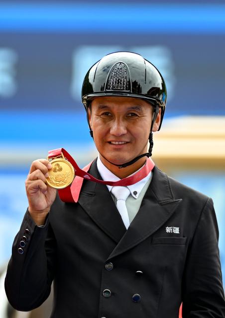 (251112) -- SHENZHEN, Nov. 12, 2025 (Xinhua) -- Gold medalist Liu Tao of Xinjiang reacts during the awarding ceremony for the equestrian dressage individual final at China's 15th National Games in Shenzhen, south China's Guangdong Province, Nov. 12, 2025. (Xinhua/Feng Kaihua)