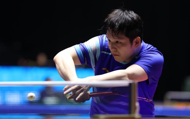 (251112) -- MACAO, Nov. 12, 2025 (Xinhua) -- Fan Zhendong hits a return during the table tennis men's singles round of 16 match between Fan Zhendong of Shanghai and Xue Fei of Hubei at China's 15th National Games in Macao, south China, Nov. 12, 2025. (Xinhua/Liang Xu)