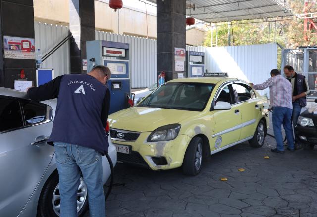 (251112) -- DAMASCUS, Nov. 12, 2025 (Xinhua) -- People refill gas tanks of their cars at a gas station in Damascus, Syria, Nov. 12, 2025. The Syrian government announced a 30 percent reduction in the prices of petroleum products and cooking gas, part of broader efforts to ease living costs. (Photo by Ammar Safarjalani/Xinhua)