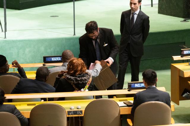 (251112) -- UNITED NATIONS, Nov. 12, 2025 (Xinhua) -- A conference officer (2nd R) collects ballots during a General Assembly meeting to elect a judge for the International Court of Justice at the UN headquarters in New York, Nov. 12, 2025. Kenyan jurist Phoebe Okowa was elected a judge of the International Court of Justice (ICJ) on Wednesday to fill the seat vacated by Somalia's Abdulqawi Yusuf, who resigned effective Sept. 30. Under the ICJ's Statute, judges are elected by secret ballot in both the Security Council and the General Assembly. (Evan Schneider/UN Photo/Handout via Xinhua)