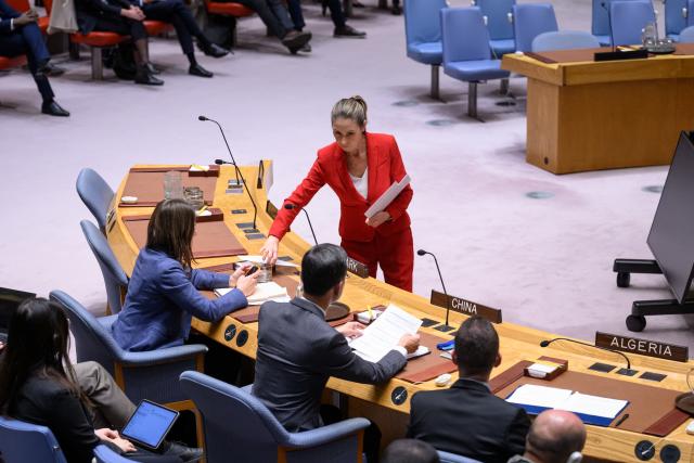 (251112) -- UNITED NATIONS, Nov. 12, 2025 (Xinhua) -- A conference officer (woman in red) hands out ballots during a Security Council meeting to elect a judge for the International Court of Justice at the UN headquarters in New York, Nov. 12, 2025. Kenyan jurist Phoebe Okowa was elected a judge of the International Court of Justice (ICJ) on Wednesday to fill the seat vacated by Somalia's Abdulqawi Yusuf, who resigned effective Sept. 30. Under the ICJ's Statute, judges are elected by secret ballot in both the Security Council and the General Assembly. (Loey Felipe/UN Photo/Handout via Xinhua)