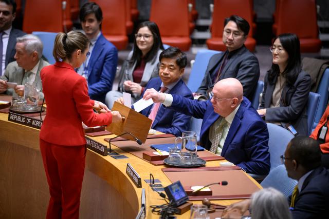 (251112) -- UNITED NATIONS, Nov. 12, 2025 (Xinhua) -- A conference officer (woman in red) collects ballots during a Security Council meeting to elect a judge for the International Court of Justice at the UN headquarters in New York, Nov. 12, 2025. Kenyan jurist Phoebe Okowa was elected a judge of the International Court of Justice (ICJ) on Wednesday to fill the seat vacated by Somalia's Abdulqawi Yusuf, who resigned effective Sept. 30. Under the ICJ's Statute, judges are elected by secret ballot in both the Security Council and the General Assembly. (Loey Felipe/UN Photo/Handout via Xinhua)