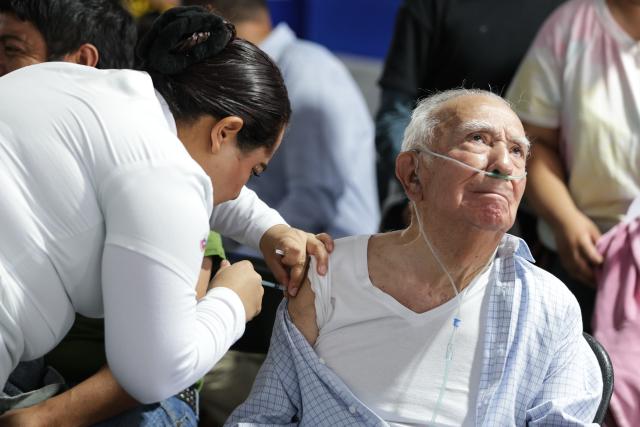 (251112) -- MEXICO CITY, Nov. 12, 2025 (Xinhua) -- A health worker administers a vaccine to an elderly man at a vaccination center in Mexico City, capital of Mexico, Nov. 12, 2025. Mexico City has set up a vaccination center offering influenza, COVID-19, pneumococcal and measles vaccines to the public as part of efforts to improve community immunization coverage during the winter season. (Photo by Francisco Canedo/Xinhua)