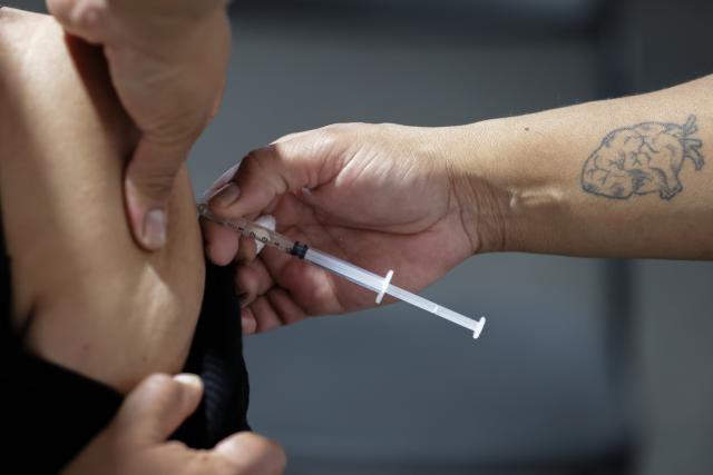 (251112) -- MEXICO CITY, Nov. 12, 2025 (Xinhua) -- A health worker administers a vaccine to a citizen at a vaccination center in Mexico City, capital of Mexico, Nov. 12, 2025. Mexico City has set up a vaccination center offering influenza, COVID-19, pneumococcal and measles vaccines to the public as part of efforts to improve community immunization coverage during the winter season. (Photo by Francisco Canedo/Xinhua)