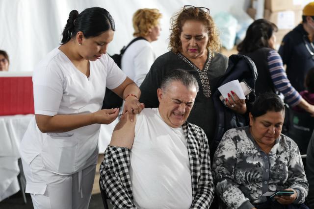 (251112) -- MEXICO CITY, Nov. 12, 2025 (Xinhua) -- A health worker administers a vaccine to a man at a vaccination center in Mexico City, capital of Mexico, Nov. 12, 2025. Mexico City has set up a vaccination center offering influenza, COVID-19, pneumococcal and measles vaccines to the public as part of efforts to improve community immunization coverage during the winter season. (Photo by Francisco Canedo/Xinhua)