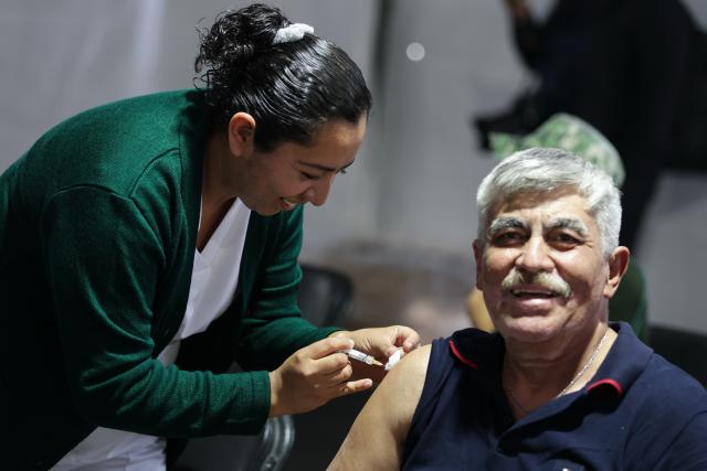 (251112) -- MEXICO CITY, Nov. 12, 2025 (Xinhua) -- A health worker administers a vaccine to a man at a vaccination center in Mexico City, capital of Mexico, Nov. 12, 2025. Mexico City has set up a vaccination center offering influenza, COVID-19, pneumococcal and measles vaccines to the public as part of efforts to improve community immunization coverage during the winter season. (Photo by Francisco Canedo/Xinhua)