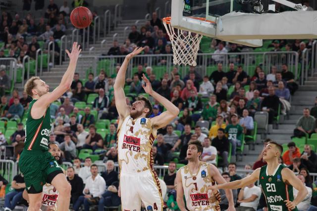 (251113) -- LJUBLJANA, Nov. 13, 2025 (Xinhua) -- Jaka Blazic (top L) of Cedevita Olimpija Ljubljana goes for a layup during the BKT Eurocup 2025/26 regular season match between Cedevita Olimpija Ljubljana and Umana Reyer Venice in Ljubljana, Slovenia, Nov. 12, 2025. (Photo by Zeljko Stevanic/Xinhua)