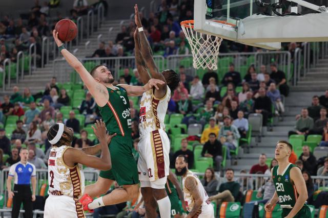 (251113) -- LJUBLJANA, Nov. 13, 2025 (Xinhua) -- Rok Radovic (top L) of Cedevita Olimpija Ljubljana goes for a dunk during the BKT Eurocup 2025/26 regular season match between Cedevita Olimpija Ljubljana and Umana Reyer Venice in Ljubljana, Slovenia, Nov. 12, 2025. (Photo by Zeljko Stevanic/Xinhua)