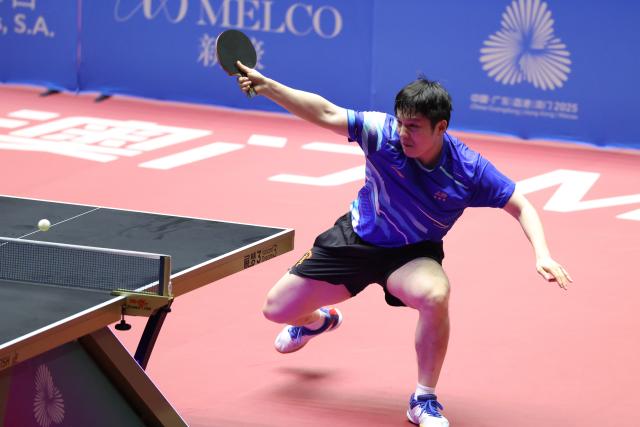 (251113) -- MACAO, Nov. 13, 2025 (Xinhua) -- Fan Zhendong hits a return during the table tennis men's singles quarterfinal match between Fan Zhendong of Shanghai and Sun Zheng of Zhejiang at China's 15th National Games in Macao, south China, Nov. 13, 2025. (Xinhua/Liu Xu)