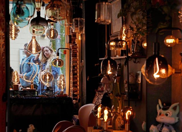 (251113) -- SHANGHAI, Nov. 13, 2025 (Xinhua) -- Pedestrians walk past a lighting store at the Yuyuan Road Historical and Cultural Block in east China's Shanghai, Nov. 12, 2025.
  The Yuyuan Road Historical and Cultural Block is a well-known neighborhood in the city's downtown area. In recent years, the block has consistently pursued an urban renewal philosophy that integrates art into daily life. By introducing independent bookstores, cafes, art studios, and other establishments, it now boasts around 80 distinctive shops, making it a must-visit destination for Shanghai's artistic youth and travelers. (Xinhua/Liu Ying)