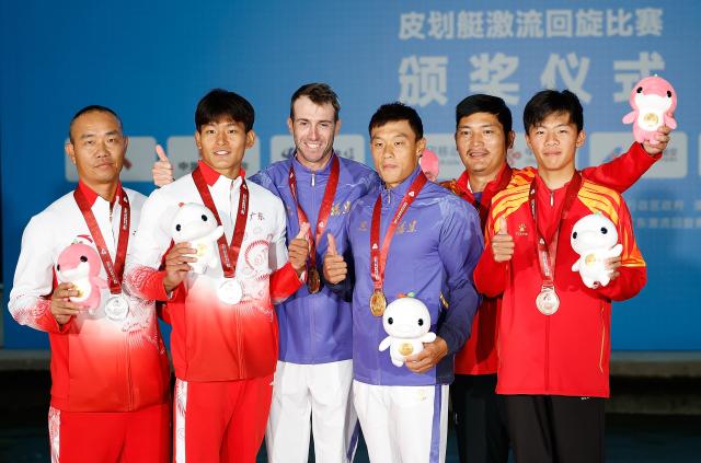 (251113) -- GUANGZHOU, Nov. 13, 2025 (Xinhua) -- Gold medalist Quan Xin of Fujian, silver medalist Hu Zhaoshan of Guangdong and bronze medalist Chen Zihuan of Jiangxi pose with their coaches during the awarding ceremony for the men's kayak single of canoe slalom at China's 15th National Games in Guangzhou, south China's Guangdong Province, Nov. 13, 2025. (Xinhua/Huang Wei)