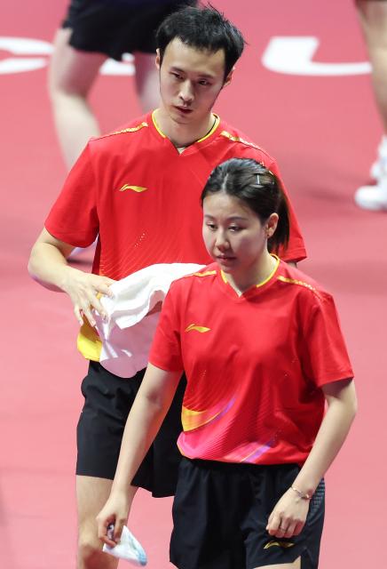 (251113) -- MACAO, Nov. 13, 2025 (Xinhua) -- Chen Xingtong (front)/Xu Haidong react during the table tennis mixed doubles semifinal match between Chen Xingtong/Xu Haidong of Liaoning and Chen Yuanyu/Kuai Man of Jiangsu at China's 15th National Games in Macao, south China, Nov. 13, 2025. (Xinhua/Liu Xu)