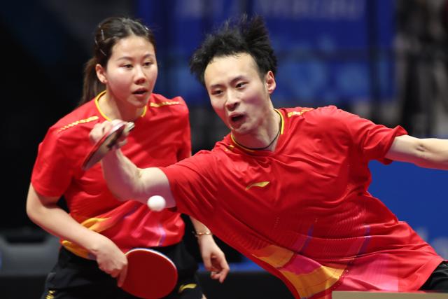 (251113) -- MACAO, Nov. 13, 2025 (Xinhua) -- Chen Xingtong/Xu Haidong (R) compete during the table tennis mixed doubles semifinal match between Chen Xingtong/Xu Haidong of Liaoning and Chen Yuanyu/Kuai Man of Jiangsu at China's 15th National Games in Macao, south China, Nov. 13, 2025. (Xinhua/Chen Bin)