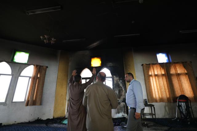 (251113) -- RAMALLAH, Nov. 13, 2025 (Xinhua) -- Palestinians inspect the aftermath of the fire at the "Hajjah Hamidah" mosque in the town of Deir Istiya, northwest of Salfit in the West Bank, Nov. 13, 2025. Israeli settlers set fire to parts of a mosque northwest of Salfit in the West Bank on Thursday and wrote anti-Islam slogans on its walls, the Palestinian Liberation Organization's Commission Against the Wall and Settlements said in a brief statement. (Photo by Nidal Eshtayeh/Xinhua)