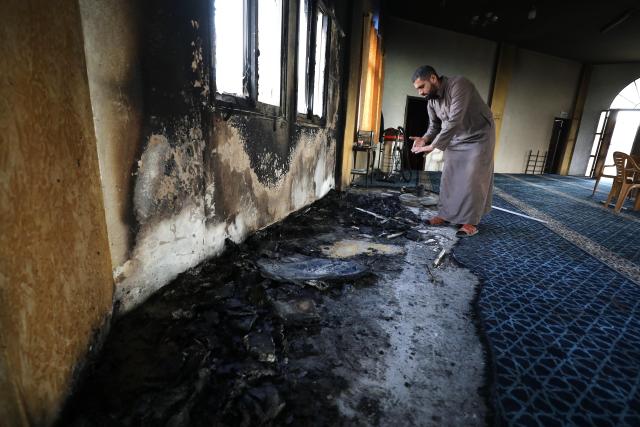 (251113) -- RAMALLAH, Nov. 13, 2025 (Xinhua) -- A Palestinian inspects the aftermath of the fire at the "Hajjah Hamidah" mosque in the town of Deir Istiya, northwest of Salfit in the West Bank, Nov. 13, 2025. Israeli settlers set fire to parts of a mosque northwest of Salfit in the West Bank on Thursday and wrote anti-Islam slogans on its walls, the Palestinian Liberation Organization's Commission Against the Wall and Settlements said in a brief statement. (Photo by Nidal Eshtayeh/Xinhua)