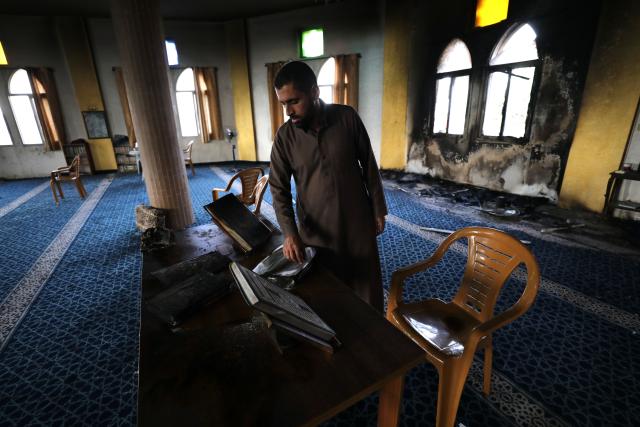 (251113) -- RAMALLAH, Nov. 13, 2025 (Xinhua) -- A Palestinian inspects the aftermath of the fire at the "Hajjah Hamidah" mosque in the town of Deir Istiya, northwest of Salfit in the West Bank, Nov. 13, 2025. Israeli settlers set fire to parts of a mosque northwest of Salfit in the West Bank on Thursday and wrote anti-Islam slogans on its walls, the Palestinian Liberation Organization's Commission Against the Wall and Settlements said in a brief statement. (Photo by Nidal Eshtayeh/Xinhua)