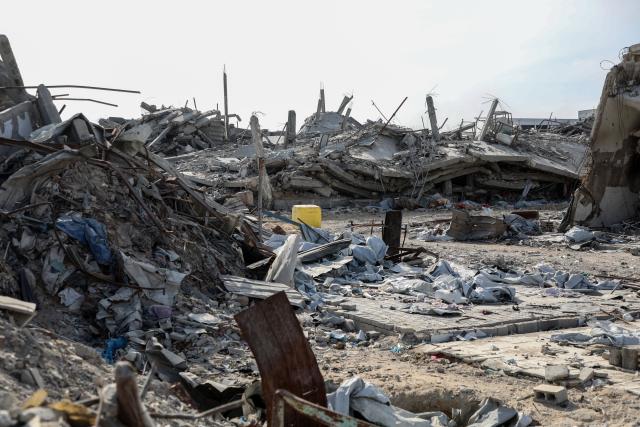 (251113) -- GAZA, Nov. 13, 2025 (Xinhua) -- A yellow-painted concrete block placed by the Israeli army that marks the Yellow Line is seen in a street with destroyed homes in Jabalia city, northern Gaza Strip, Nov. 2, 2025. TO GO WITH Feature: Gaza's new divide -- "Yellow Line" shapes life under fragile ceasefire (Photo by Rizek Abdeljawad/Xinhua)