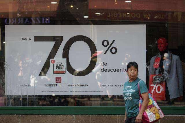 (251113) -- MEXICO CITY, Nov. 13, 2025 (Xinhua) -- A woman walks past a store at the first day of the special sales event known as "El Buen Fin," in Mexico City, capital of Mexico, Nov. 13, 2025. (Xinhua/Francisco Canedo)