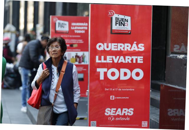 (251113) -- MEXICO CITY, Nov. 13, 2025 (Xinhua) -- A woman walks past a store at the first day of the special sales event known as "El Buen Fin," in Mexico City, capital of Mexico, Nov. 13, 2025. (Xinhua/Francisco Canedo)