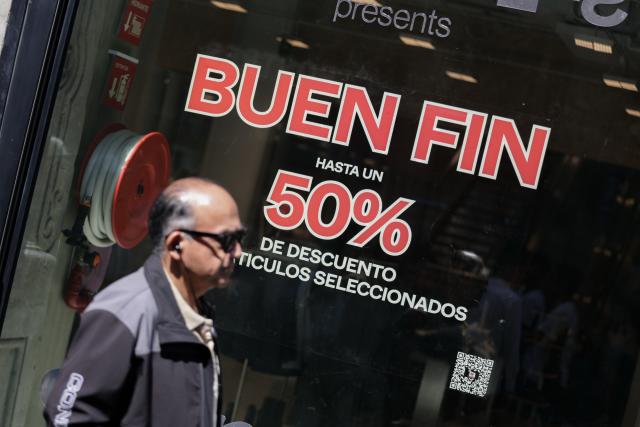 (251114) -- BEIJING, Nov. 14, 2025 (Xinhua) -- A man walks past a store at the first day of the special sales event known as "El Buen Fin" in Mexico City, capital of Mexico, Nov. 13, 2025.
  (Xinhua/Francisco Canedo)
