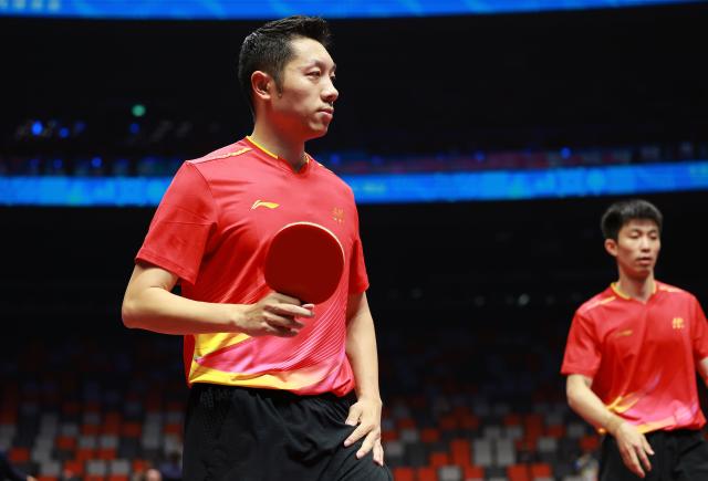 (251114) -- MACAO, Nov. 14, 2025 (Xinhua) -- Xu Xin (front)/Zhou Kai of Shanghai react during the match against Cao Yantao/Chen Yaxuan of Jiangsu during the men's team group A match of table tennis between Shanghai and Jiangsu at China's 15th National Games in Macao, south China, Nov. 14, 2025. (Xinhua/Liang Xu)