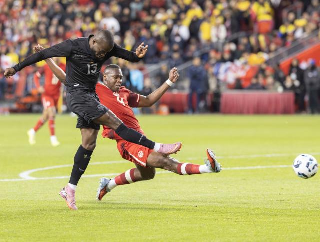 (251114) -- TORONTO, Nov. 14, 2025 (Xinhua) -- Enner Valencia Lastra (front) of Ecuador vies with Kamal Miller of Canada during a friendly football match between Canada and Ecuador at BMO Field in Toronto, Canada, on Nov. 13, 2025. (Photo by Zou Zheng/Xinhua)