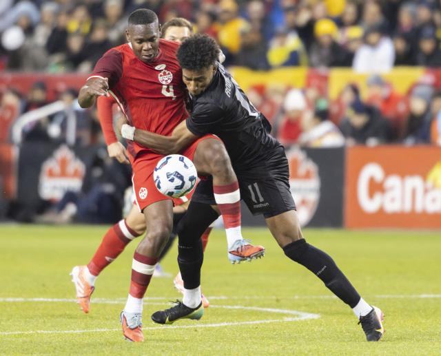 (251114) -- TORONTO, Nov. 14, 2025 (Xinhua) -- Kamal Miller (L) of Canada vies with Kevin Rodriguez Cortez of Ecuador during a friendly football match between Canada and Ecuador at BMO Field in Toronto, Canada, on Nov. 13, 2025. (Photo by Zou Zheng/Xinhua)