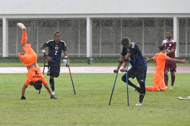 (251114) -- JAKARTA, Nov. 14, 2025 (Xinhua) -- Yadolah Gholami Zali (1st L) of Iran celebrates after the match between Iran and Japan at the Asian Amputee Football Cup Qualifiers 2025 in Jakarta, Indonesia, Nov. 14, 2025. (Xinhua/Agung Kuncahya B.)