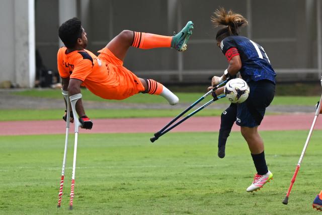 (251114) -- JAKARTA, Nov. 14, 2025 (Xinhua) -- Akbar Lotfimoghaddam (L) of Iran vies with Daiki Goto of Japan during the match between Iran and Japan at the Asian Amputee Football Cup Qualifiers 2025 in Jakarta, Indonesia, Nov. 14, 2025. (Xinhua/Agung Kuncahya B.)