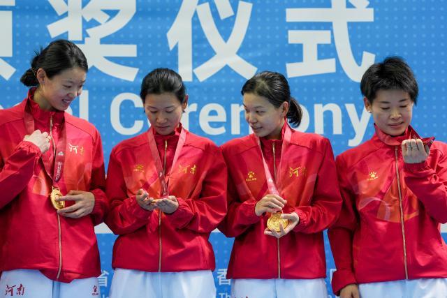 (251114) -- HONG KONG, Nov. 14, 2025 (Xinhua) -- Members of team Henan react during the awarding ceremony for the cycling track women's team pursuit at China's 15th National Games in Hong Kong, south China, Nov. 14, 2025. (Xinhua/Wu Lu)