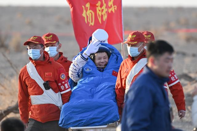 (251114) -- JIUQUAN, Nov. 14, 2025 (Xinhua) -- Wang Jie, a Shenzhou-20 astronaut, is out of the Shenzhou-21 spaceship's return capsule after it touched down on Earth at the Dongfeng landing site in north China's Inner Mongolia Autonomous Region, Nov. 14, 2025. (Xinhua/Li Zhipeng)