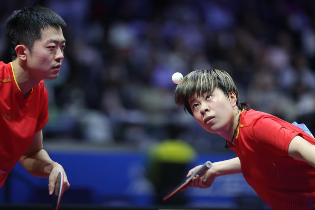 (251114) -- MACAO, Nov. 14, 2025 (Xinhua) -- Wang Yidi (R)/Yuan Licen compete during the mixed doubles bronze medal match of table tennis between Chen Xingtong/Xu Haidong of Liaoning and Wang Yidi/Yuan Licen of Liaoning at China's 15th National Games in Macao, south China, Nov. 14, 2025. (Xinhua/Liu Xu)