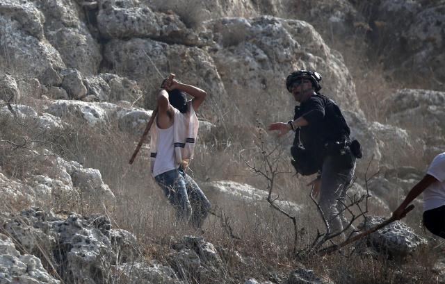 (251114) -- BEITA, Nov. 14, 2025 (Xinhua) -- Israeli settlers attack a journalist in the village of Beita, south of Nablus in the West Bank, on Nov. 8, 2025. TO GO WITH: "Letter from Mideast: Fear permeates harvest season in olive groves" (Photo by Nidal Eshtayeh/Xinhua)
