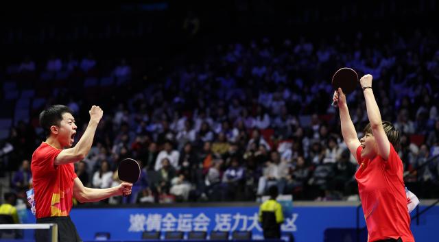 (251114) -- MACAO, Nov. 14, 2025 (Xinhua) -- Wang Yidi/Yuan Licen (L) celebrate winning the mixed doubles bronze medal match of table tennis between Chen Xingtong/Xu Haidong of Liaoning and Wang Yidi/Yuan Licen of Liaoning at China's 15th National Games in Macao, south China, Nov. 14, 2025. (Xinhua/Sun Fanyue)