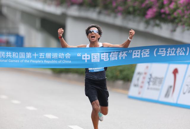 (251115) -- SHENZHEN, Nov. 15, 2025 (Xinhua) -- He Jie of Ningxia crosses the finish line during the men's marathon event at China's 15th National Games in Shenzhen, south China's Guangdong Province, Nov. 15, 2025. (Xinhua/Ding Ting)