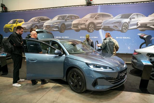 (251115) -- PRAGUE, Nov. 15, 2025 (Xinhua) -- People visit the exhibition area of BYD at the 7th e-SALON in Prague, the Czech Republic, Nov. 14, 2025.
  The e-SALON, a trade fair for passenger and commercial vehicles with alternative propulsion, opened to public on Friday and will last until Sunday. (Photo by Dana Kesnerova/Xinhua)